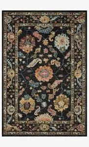 Black wool rug with multicolored floral and paisley motifs, thick hooked pile, and decorative border