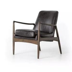 Black leather accent chair with sculpted dark wood frame and deep cushioned seat in mid-century modern style