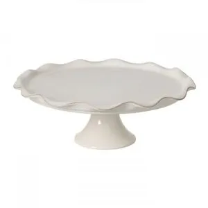 White ceramic stoneware footed plate with a large round surface and wavy scalloped edge