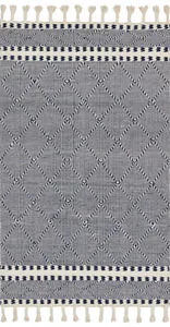 Sawyer navy rug with bold diamond graphic pattern, hand-loomed wool and cotton fibers, finished with playful fringes