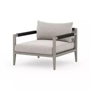 Outdoor lounge chair with light wood frame, stone grey cushions, and black wrapped armrests