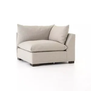 Neutral beige low-and-deep lounge sectional piece with knife edge cushioning and plush back pillows