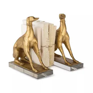 Gold dog-shaped bookends with sleek, elongated forms on clear rectangular bases holding aged books upright