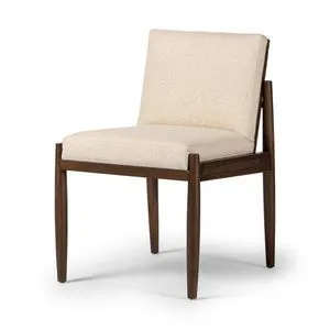 Costera Dining Chair angled view showing tapered legs and rattan side panels