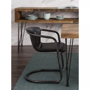 Freeman dining chair with black distressed leather seat and backrest and bent black iron cantilever frame