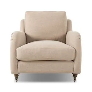 Lynne Chair with rolled arms, sink-in cushions, turned wood legs with casters, upholstered in soft beige linen-cotton blend