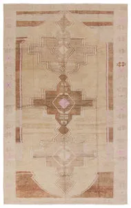 Southwestern-inspired medallion rug with tan, pink, brown, and cream hues in a distressed vintage style