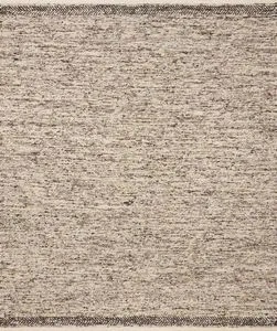 Reyla Granite Mocha rug with a heathered beige and mocha speckled pattern and dark herringbone border