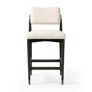 Anton Stool with light performance fabric seat and back, tapered solid oak legs, and iron-dipped caps in dark finish