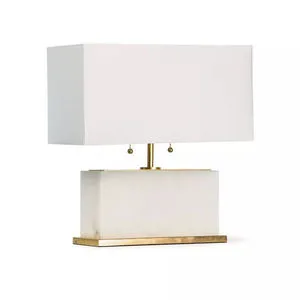 Table lamp with a natural alabaster rectangular base and a large white rectangular shade, balanced on a brass platform