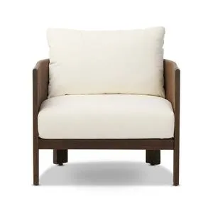 Barrel-backed outdoor chair with simple shaping and linear woven cording finish in brown with white cushions