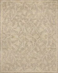 Handmade wool rug with a natural palette featuring ribbed high-low pile and subdued motifs in background base