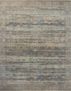 Traditional rug with vintage aesthetic in blue, beige, and subtle orange tones, featuring a distressed, variable-pile text...
