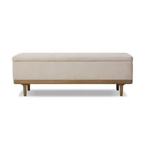 Spacious rectangular trunk with cream textured fabric upholstery and worn oak frame and tapered legs