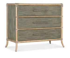 Two-tone Retreat Pole Rattan chest with sand-colored frame and seagrass green drawer fronts, featuring three textured bar ...