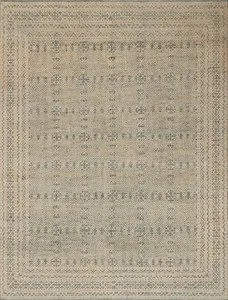 rectangular rug with intricate blue and natural geometric patterns in a faded, vintage-inspired style