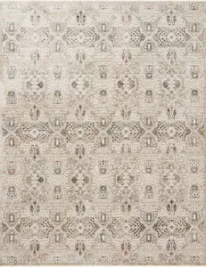 Ivory and granite rug with a geometric pattern, subtle pile height variation, and a refined fringe border