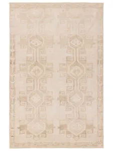 Tan and cream distressed rug with Southwestern-inspired medallion pattern and geometric border