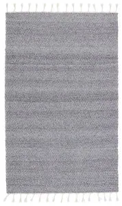 Solid gray and white handwoven indoor/outdoor rug with tassels on short ends, flat textured surface