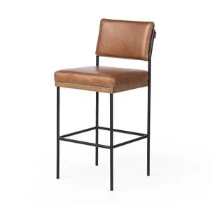 Benton Stool angled to show square footrest and side profile of leather seat cushioning