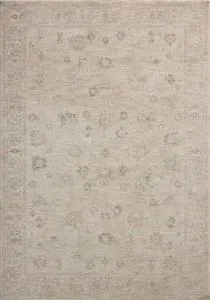 Traditional Turkish-style rectangular area rug with pale blue, cream, and brown muted patterns on oatmeal background