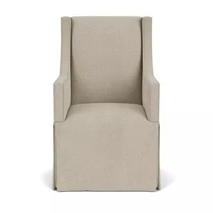 Front view of chair showing symmetrical arms and streamlined upholstery with tailored skirt