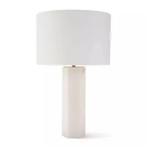 Stella Alabaster Table Lamp with a white cylindrical fabric shade and a tall, hexagonal alabaster base.