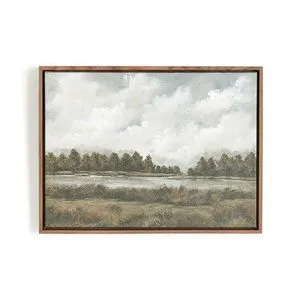 Framed landscape painting depicting a tranquil water body bordered by trees under a cloudy sky in muted natural tones