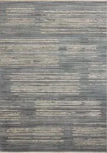 Wade Ocean Sand rug with abstract linear motifs in soft blue, gray, and sand tones with distressed texture and fringed edges