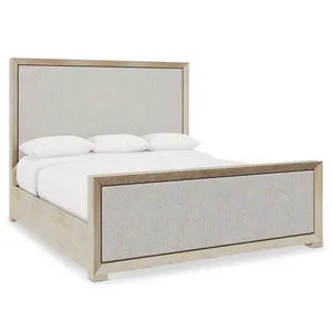 Prado panel bed with tawny wood frame and soft beige upholstered headboard and footboard panels