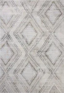Ivory-toned area rug with classic geometric diamond motifs and fringeless edges in neutral shades