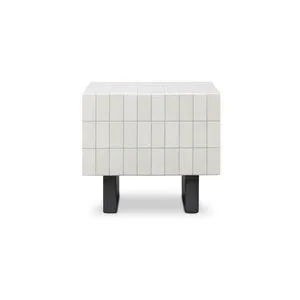 Square outdoor side table with glazed concrete top featuring a white grid pattern and matte black metal-inspired legs