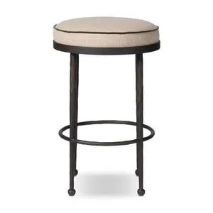 Counter stool with round beige cushioned seat and hammered iron legs with ball-shaped feet