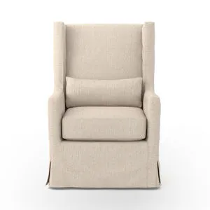 Front view of swivel chair showing full wingback and pleated skirt detailing