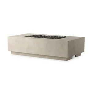 Rectangular outdoor fire table in a light gray smooth finish with black lava stones in recessed center