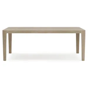 Rectangular outdoor dining table made of teak in Sea Oat finish with rounded slatted top corners and tapered legs.