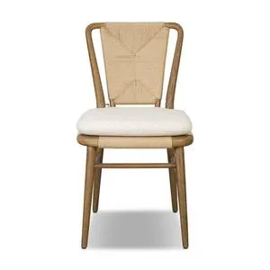 Greylin Dining Chair with woven backrest, curved wood frame, and cream cushion tied with fabric cords