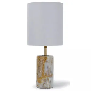 Mini cylinder table lamp with solid jade stone base in white and amber hues, natural brass hardware, and tall natural line...