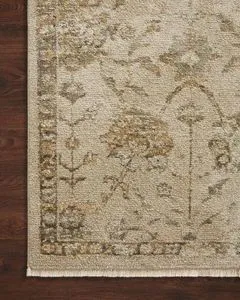 Detailed close-up of Giada Silver Sage Rug pile showing fiber texture and intricate flower and border design on dark wood ...