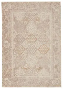Lourdes Trellis rug in gold and light gray with a distressed mosaic pattern and ornate vintage-style border