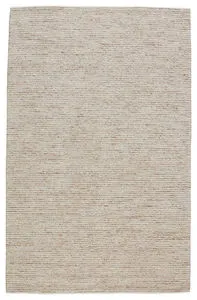 Handwoven solid beige area rug with cream and light brown jute, viscose, and wool blend in a subtle linear pattern