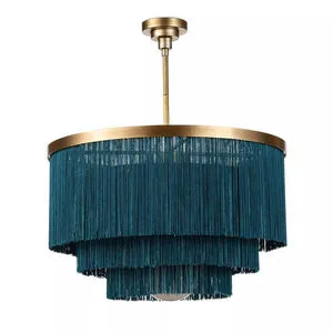 Cabaret Fringe Chandelier with three layers of teal fringe, natural brass frame, and opal glass dome diffuser