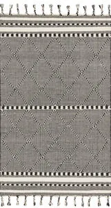 Sawyer Black Rug with bold black and white diamond geometric pattern and playful fringe on short sides