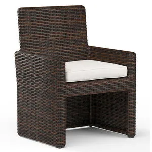 Montecito Dining Chair in rich Cognac multi-colored resin wicker with white seat cushion and armless design