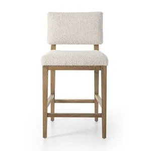 Modern bar stool with toasted oak frame and cream fabric upholstery featuring a split back design