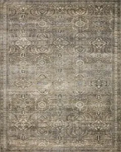 Flat lay of entire rug revealing full traditional symmetrical pattern and faded moss and beige color palette