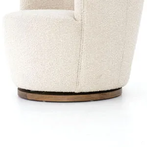 Close-up of textured natural cream upholstery and dark wooden swivel base