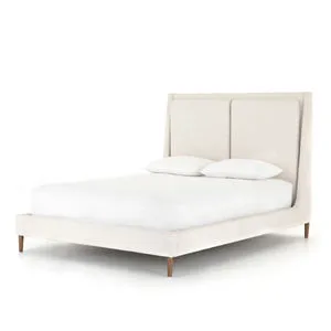 Potter Queen Bed in cream linen-blend with tapered headboard featuring fixed overscale pillows and wire-brushed parawood legs