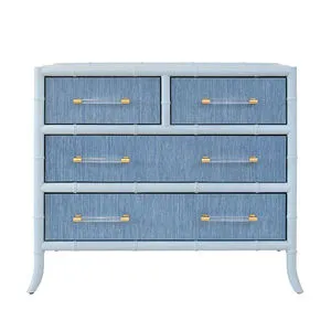 Blue grasscloth Beckett Chest with bamboo-inspired white frame and four drawers featuring clear acrylic and brass handles