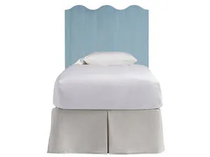 Light blue scalloped Surf City Bed Headboard with visible wood grain, styled on a bed with white bedding and beige skirt